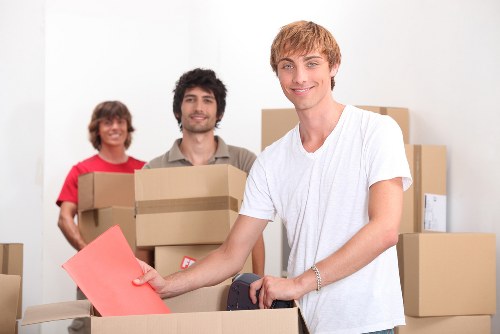 Team preparing packed office equipment for transport in Windsor