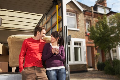 Professional removalists unloading boxes and furniture at a Windsor home